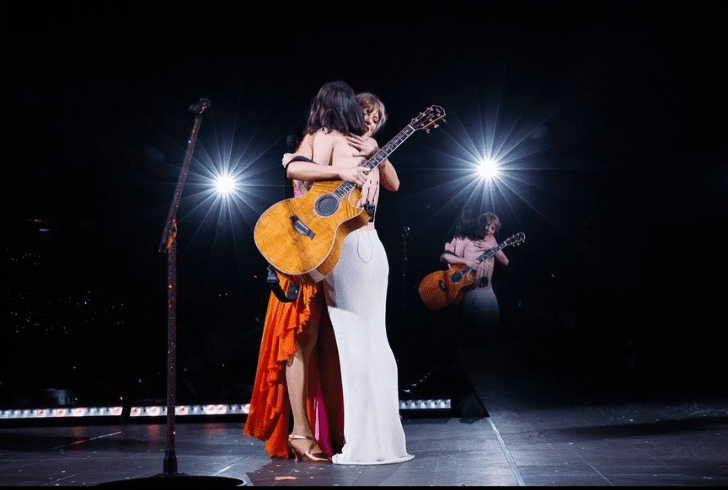 Gracie Abrams and Taylor Swift on stage.